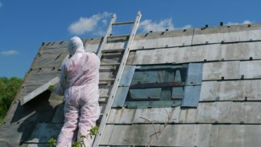 Asbestos removal worker in protective suit