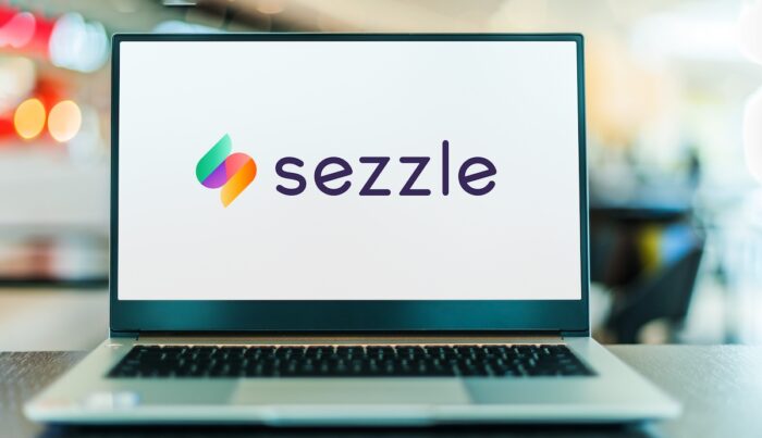 Laptop computer displaying logo of Sezzle.