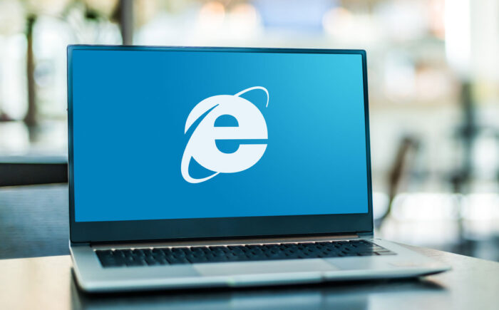 Laptop computer displaying logo of Internet Explorer, a web browser developed by Microsoft.