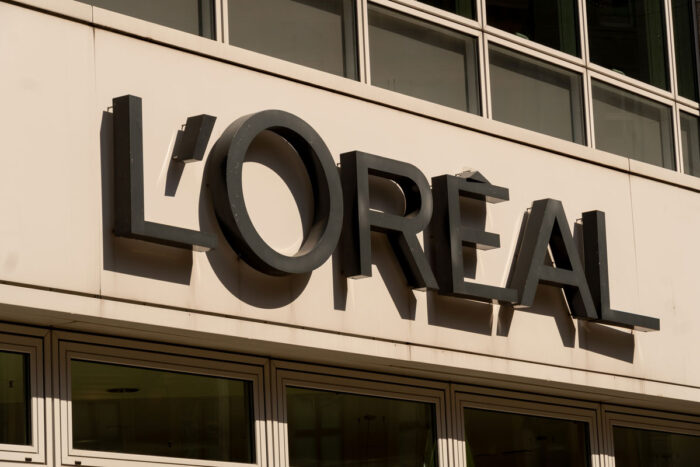 Close up of L'Oreal signage on exterior of building.