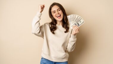Happy woman with cash in hand