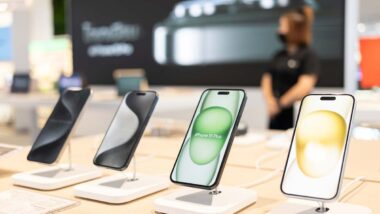 Close up of iPhones for sale on display in an Apple store, representing the Apple antitrust lawsuit.