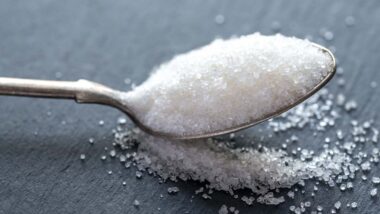 Close up of a spoon of sugar, representing the sugar price-fixing class action.