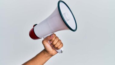 Close up of a hand holding a megaphone, representing top recalls for the week of April 15.