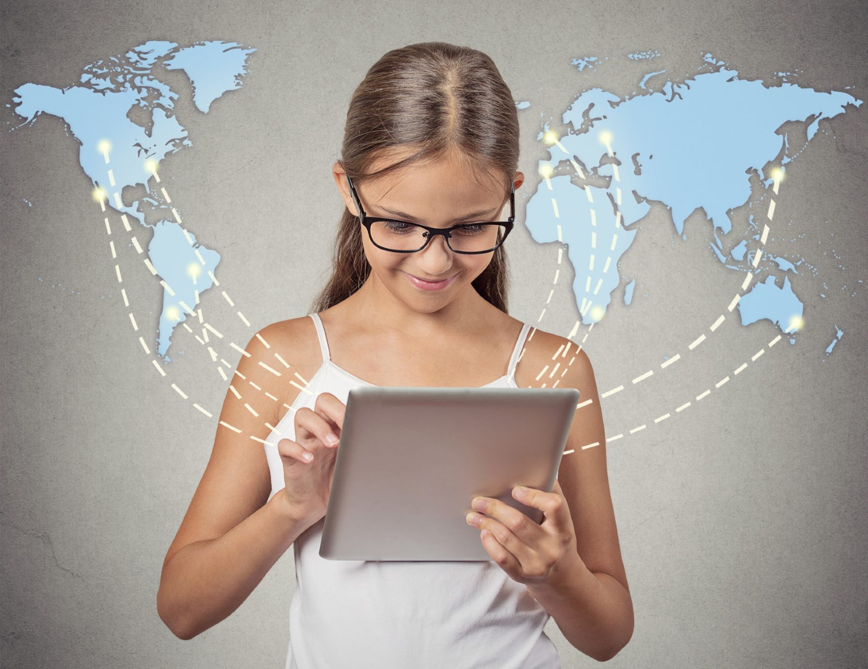 A girl wearing glasses uses an iPad as a world map projects out from it - Children's Code