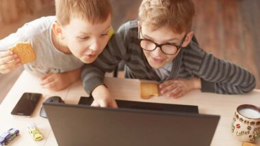 Two young boys using a laptop, representing the Online Safety Act.