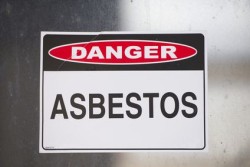 Asbestos danger sign warning on glass
