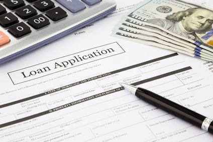 loan application form and dollar banknotes