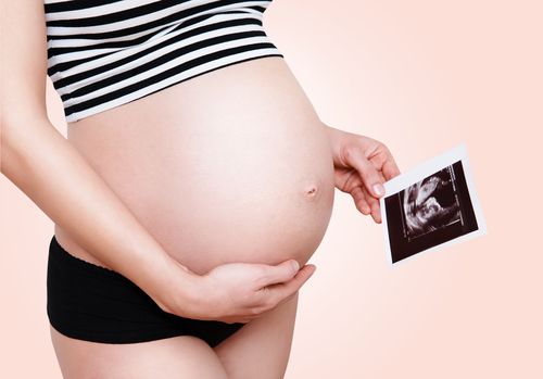 pregnant-woman-holding-ultrasound-image
