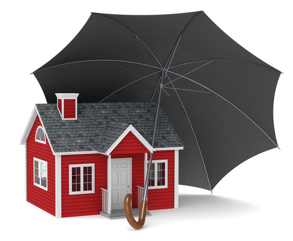 A red house protected by an umbrella - liberty insurance