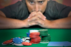 Stressed man in a poker table gambling