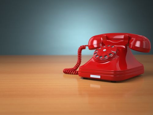 Vintage phone on green background. Hotline support concept. 3d