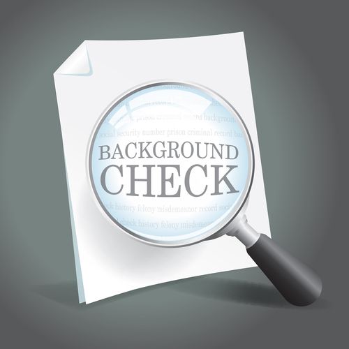 Reviewing a background check report with a magnifying glass.
