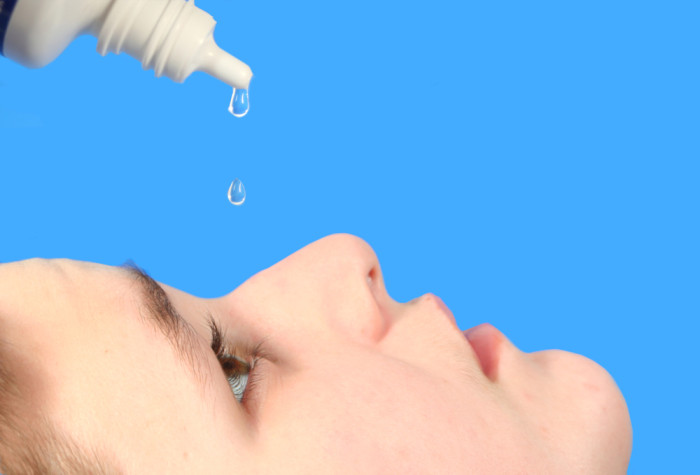 putting eye drops into dry eyes