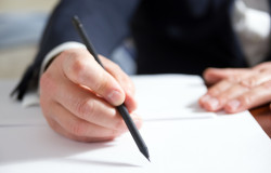 Businessman's hand signing papers. Lawyer, realtor, businessman sign documents on white background.
