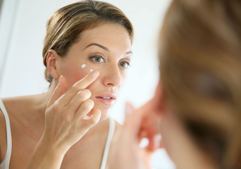 Woman-applying-face-cream