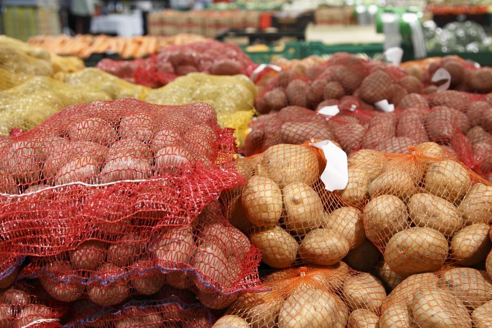 Big potatoes placed in bags in supermarkets