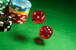 Rolling red dice on a casino table