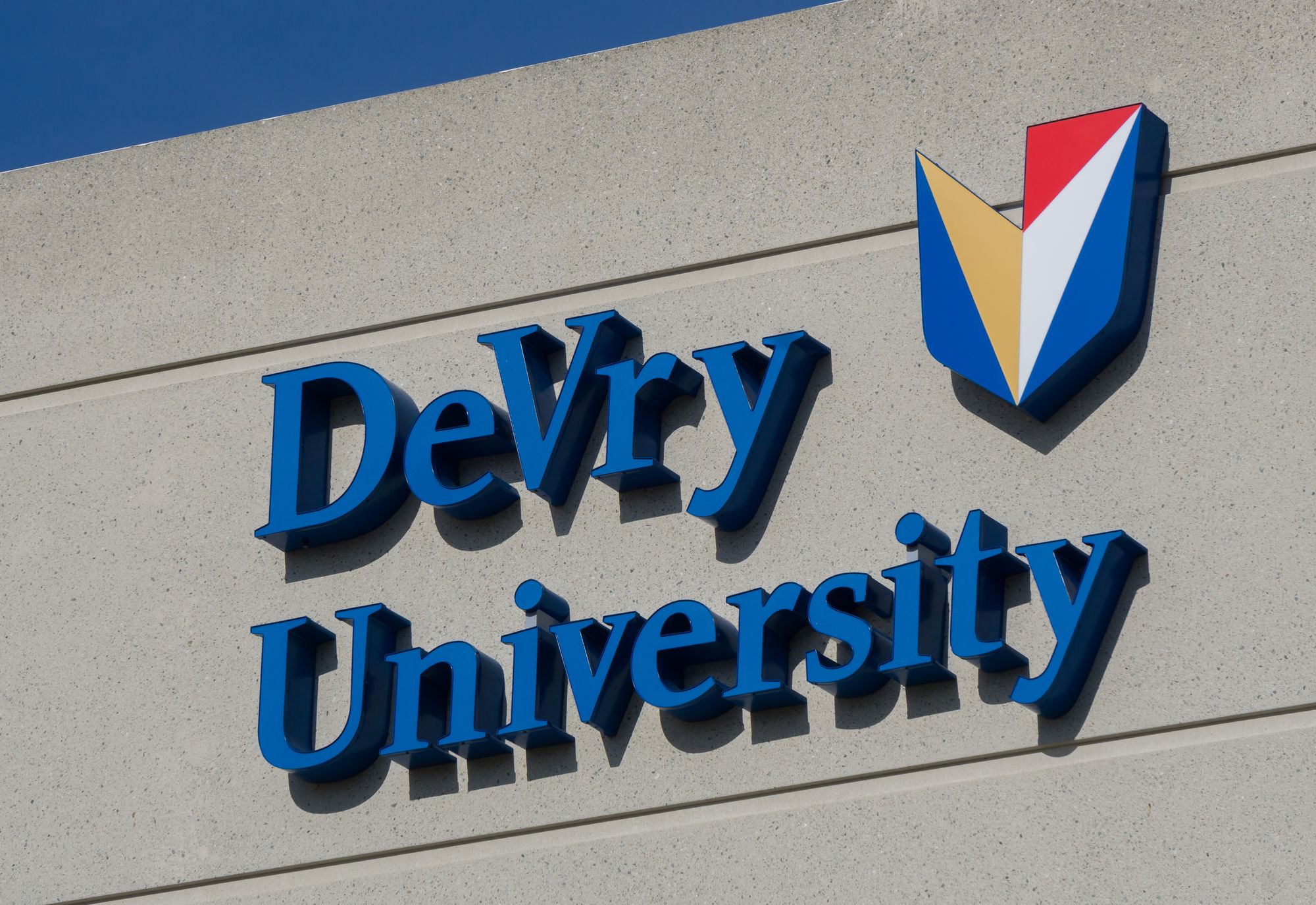 LONG BEACH, CA/USA - MARCH 19, 2016: DeVry University exterior and logo. DeVry University is a for-profit higher education organization.