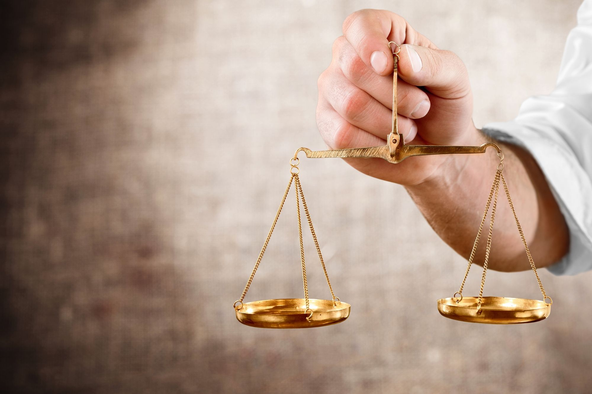 Image of a person holding the scales of justice - class action lawsuit