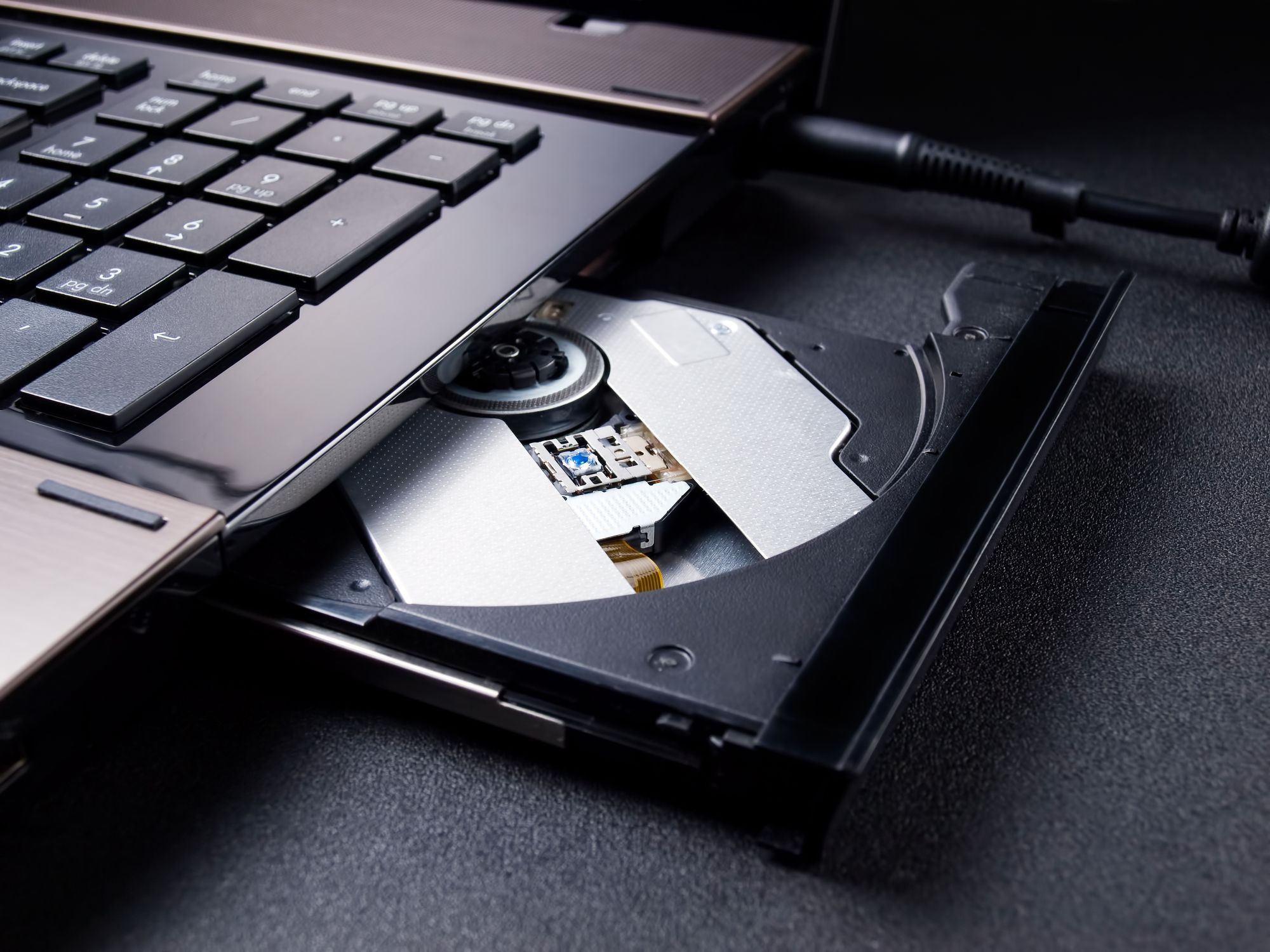 Open optical disc drive on a modern laptop computer without disc.