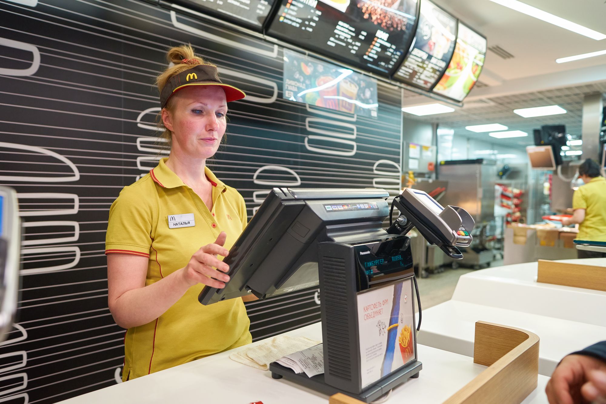 SAINT PETERSBURG, RUSSIA - CIRCA NOVEMBER, 2016: worker at McDonald's restaurant. McDonald's primarily sells hamburgers, cheeseburgers, chicken, french fries, breakfast items, soft drinks, milkshakes, desserts