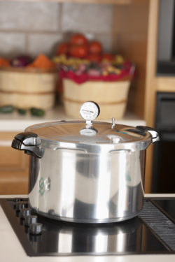 An image of a pressure cooker used for canning homegrown fruits and vegetables.