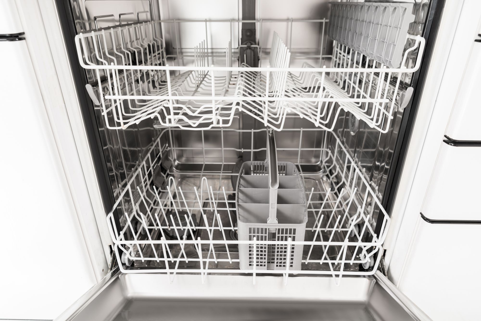 Close-up Photo Of An Empty Opened Dishwasher