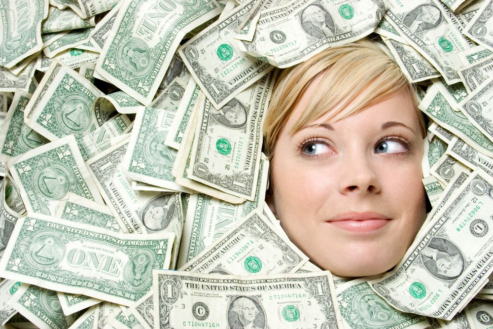 Blond woman surrounded by money