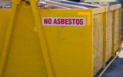 Large yellow skip bin filled with building waste showing No Asbestos sticker