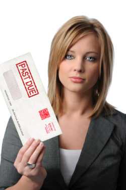 Beautiful young woman holding Past Due envelope isolated over white