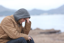 Worried teenage boy crying on the beach in winter , risperdal,