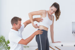 Doctor examining his patient back in medical office
