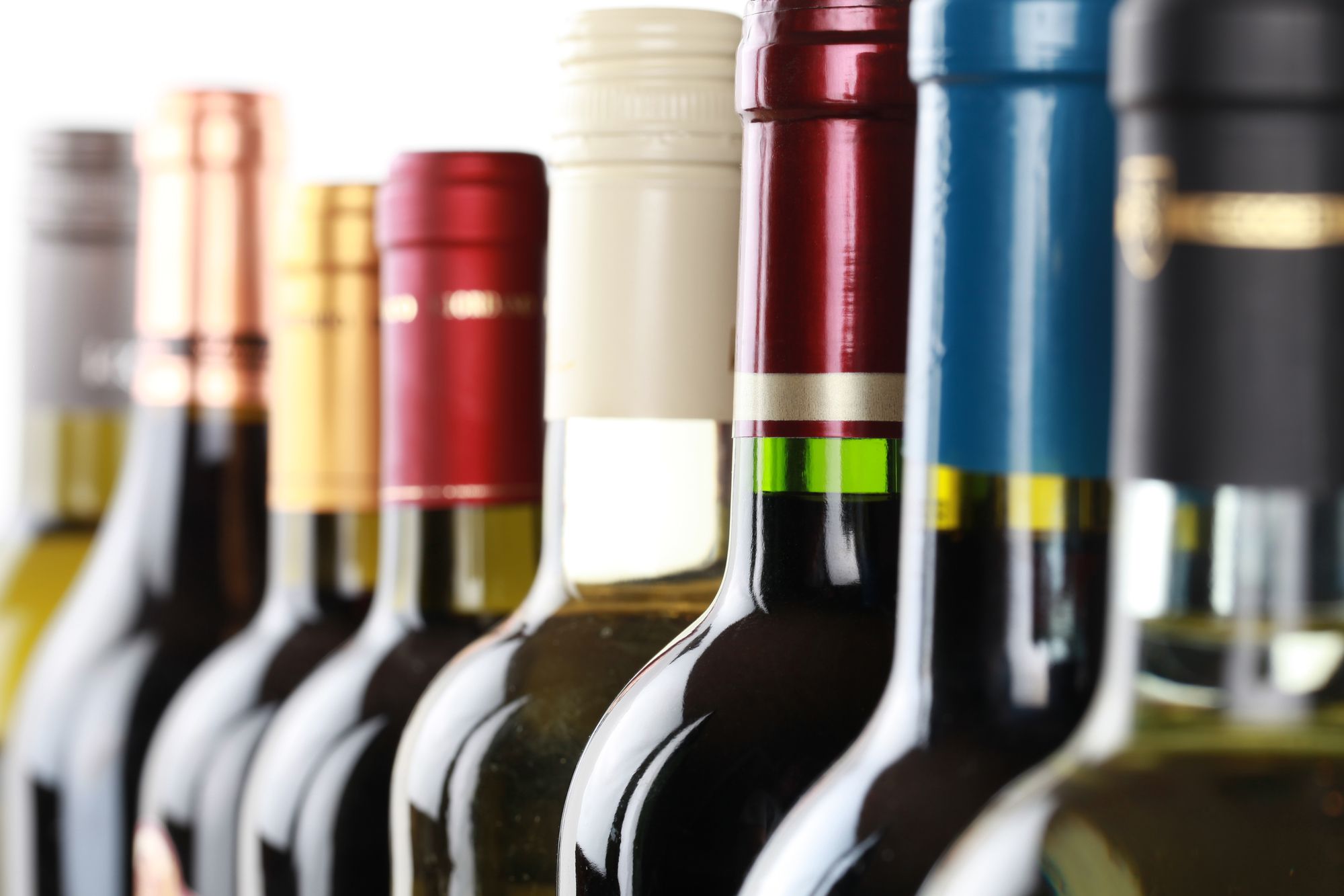 Wine bottles in a row isolated on a white background