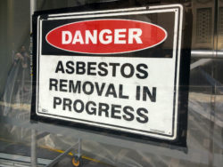 AUCKLAND - AUG 01 2015:Sign reads: Danger - Asbestos removal in progress.Inhalation of asbestos fibers can cause serious and fatal illnesses including lung cancer, mesothelioma and asbestosis.