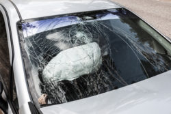 Road accident crash damaged car or wreck broken vehicle with used airbag