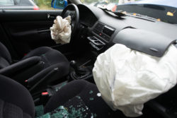 Detail of damaged car with deployed airbags