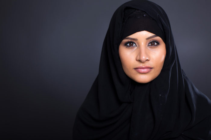 attractive Muslim woman on black background