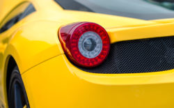 Ferrari odometer Close-up view of yellow sports car rear light.