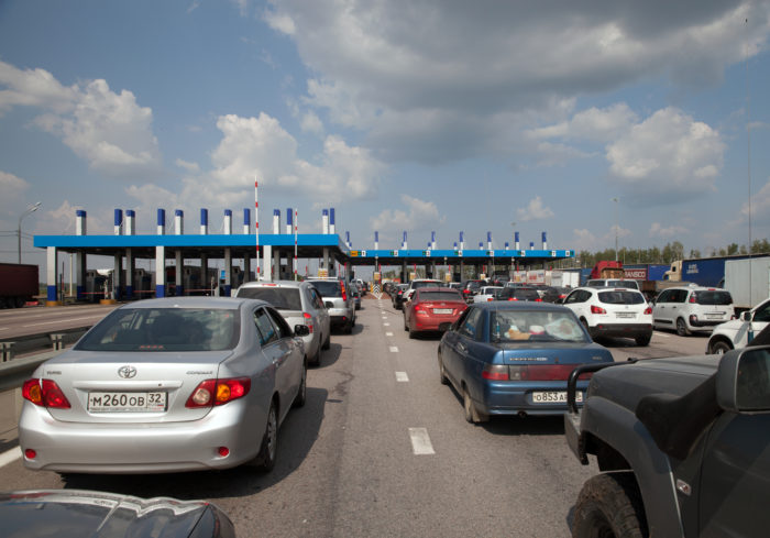 electronic toll road violation fees cars waiting for toll booth