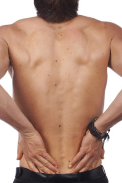 Back of a man with black liver spots on the skin