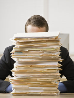 lawyer behind a stack of files