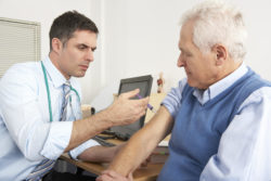 Physician giving shingles vaccine to patient