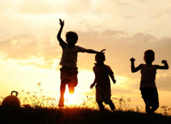 silhouettes of children playing in the sunset