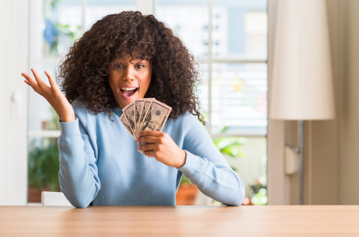 woman holding settlement cash money