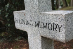 A headstone reads in loving memory