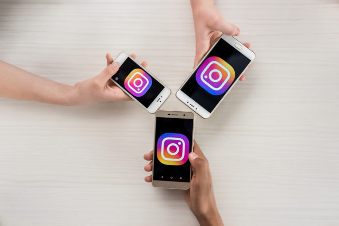 teens with their smartphones using the instagram app