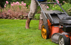 A man mowing a lawn.