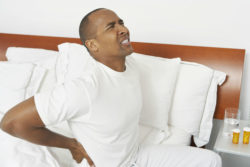 Man with hip pain in bed