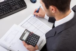 Tax accountant at desk completing client's taxes